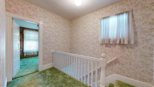 a view of a door and wooden floor