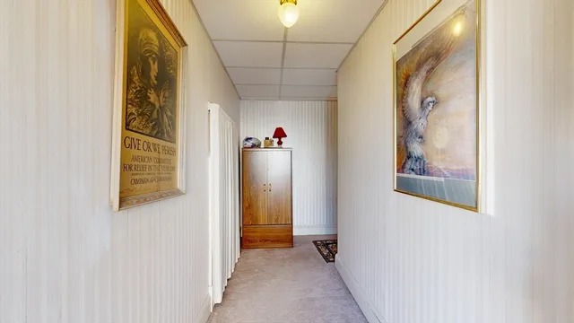 a view of a hallway with paintings on the wall