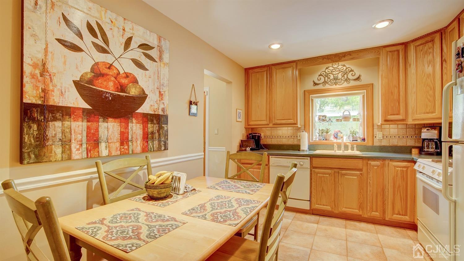 9 Tremblay Road East Brunswick, NJ 08816 - Photo 3 of 25 a large kitchen with a table and chairs in it