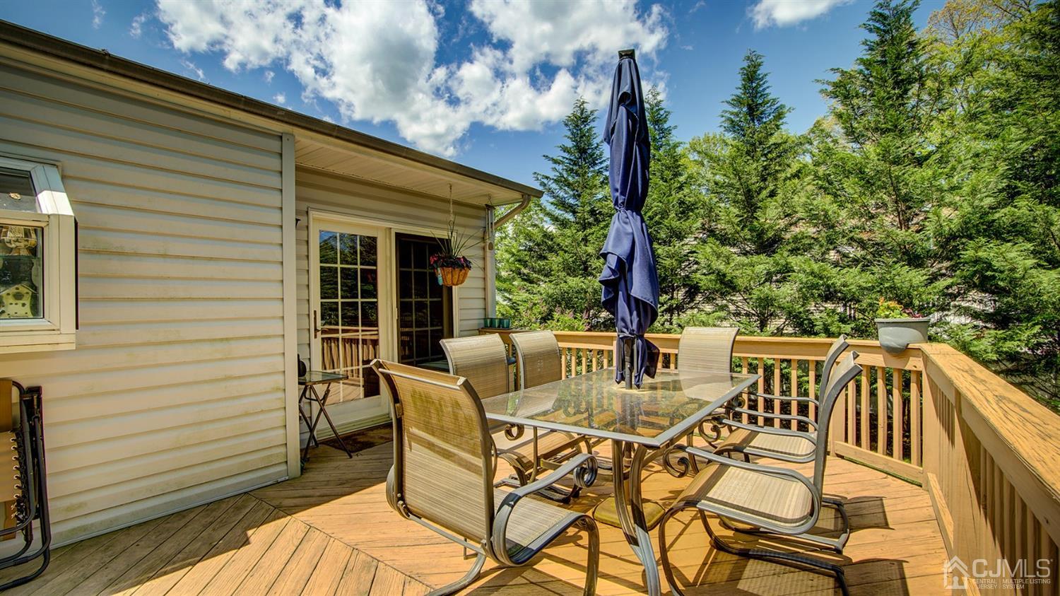 9 Tremblay Road East Brunswick, NJ 08816 - Photo 23 of 25 a view of a patio with table and chairs with wooden floor and fence