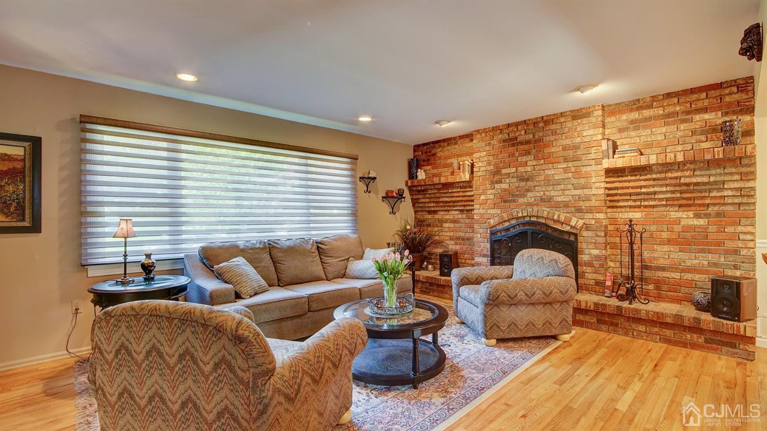 9 Tremblay Road East Brunswick, NJ 08816 - Photo 4 of 25 a living room with furniture wooden floor and a fireplace