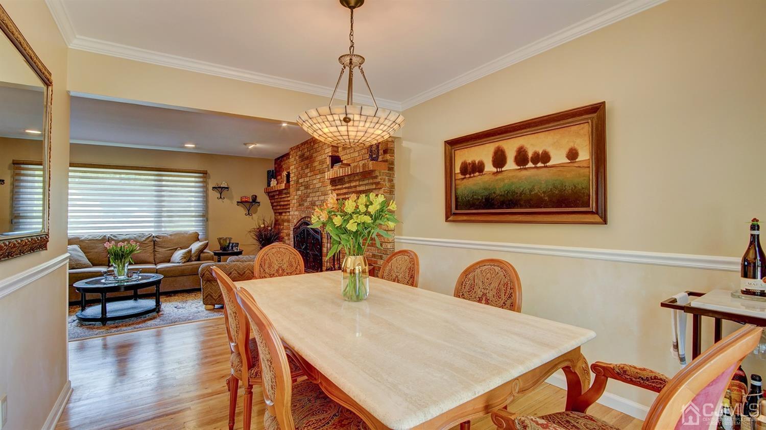 9 Tremblay Road East Brunswick, NJ 08816 - Photo 6 of 25 a living room with dining table furniture and a chandelier