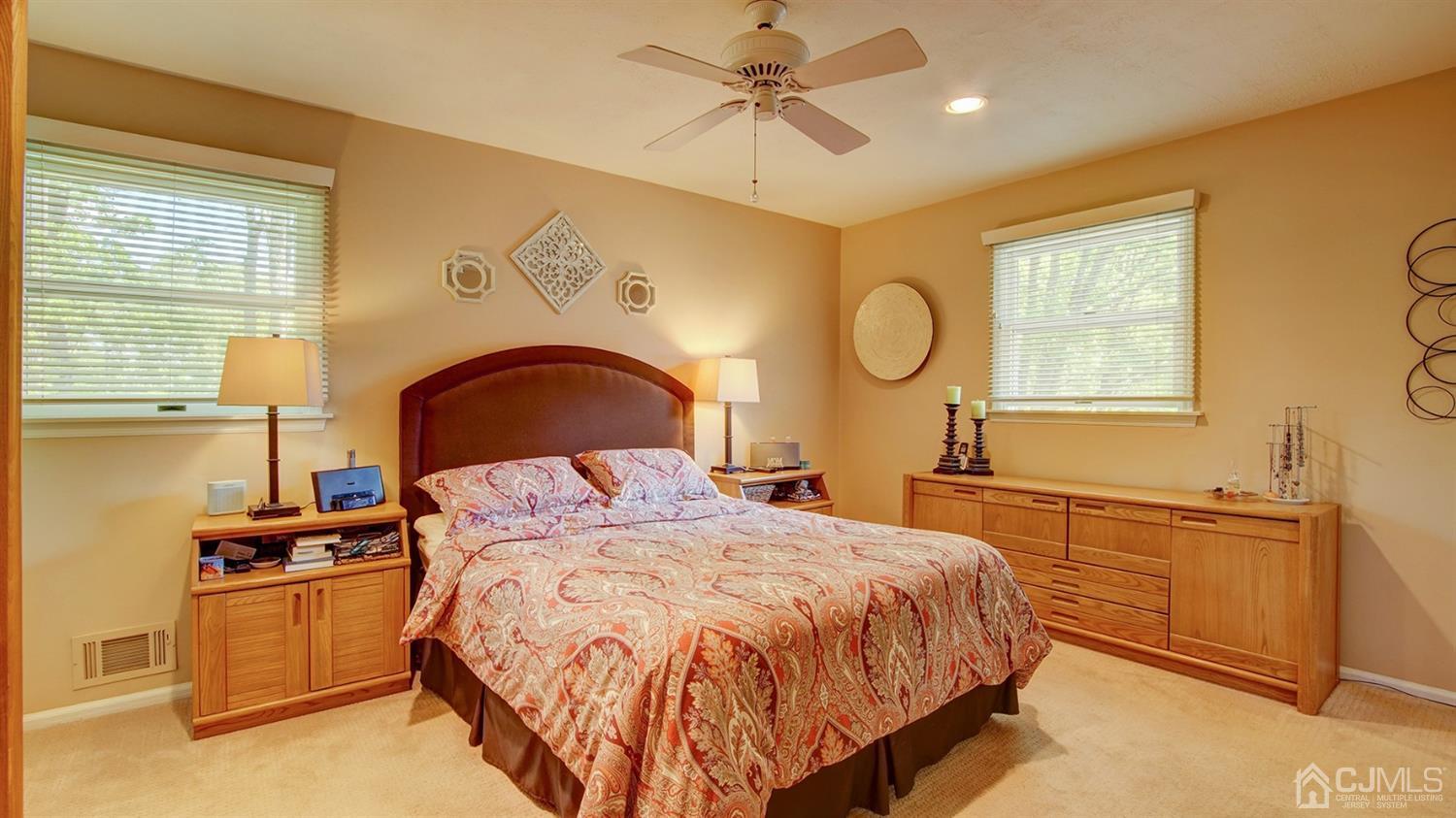 9 Tremblay Road East Brunswick, NJ 08816 - Photo 10 of 25 a bedroom with a bed and dresser with mirror