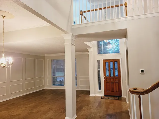 a view of an entryway with wooden floor