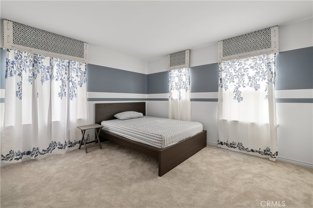 17408 Winter Pine Way Canyon Country, CA 91387 - Photo 13 of 29 a bedroom with a bed lamp and window