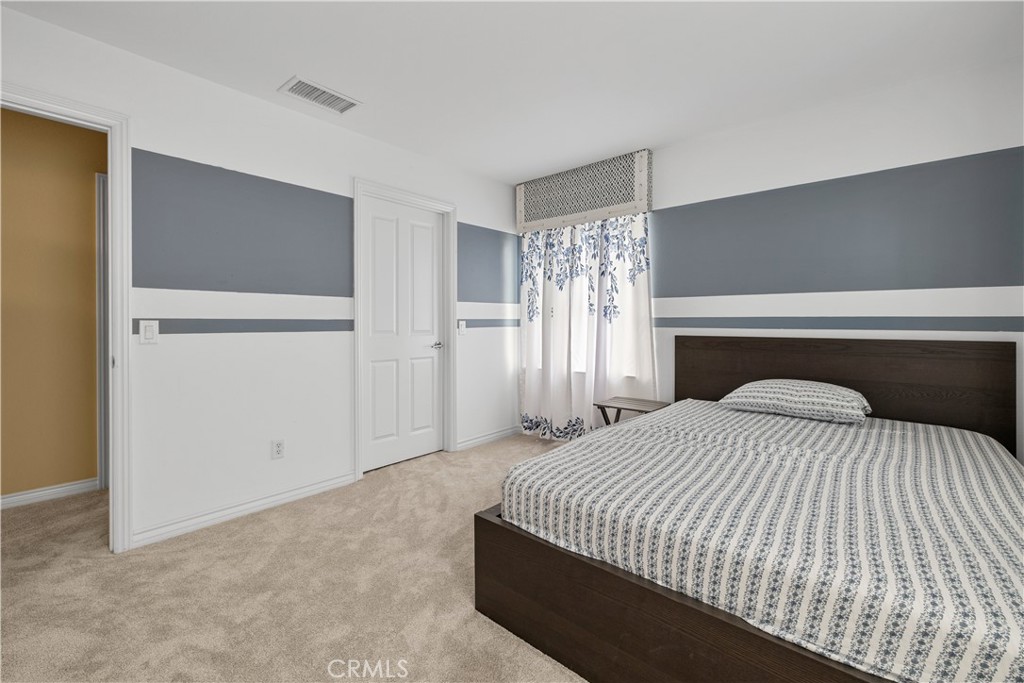 17408 Winter Pine Way Canyon Country, CA 91387 - Photo 14 of 29 a bedroom with a large bed and a chandelier