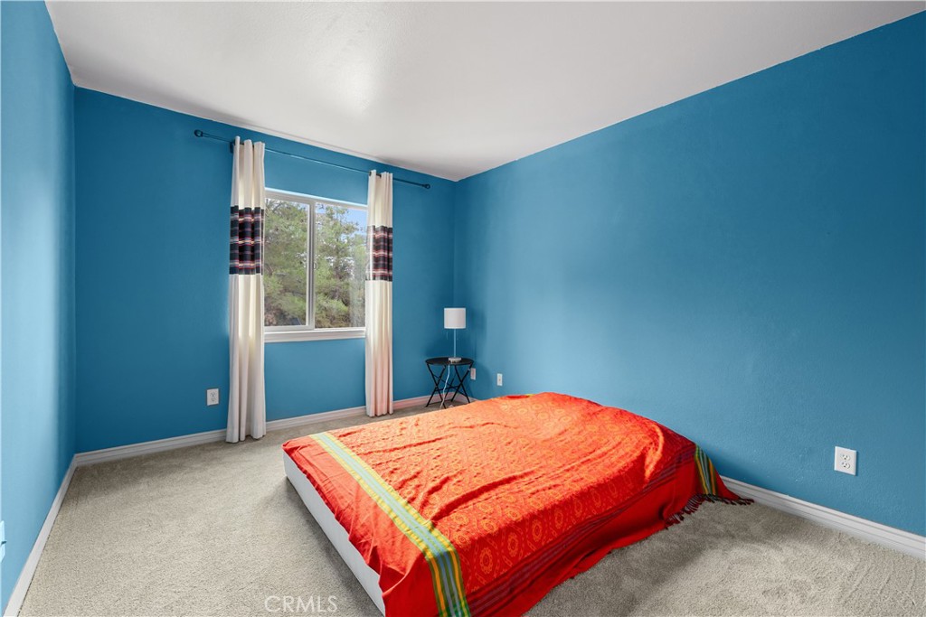 17408 Winter Pine Way Canyon Country, CA 91387 - Photo 15 of 29 a bedroom with a bed and window