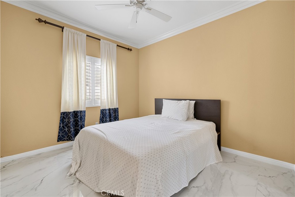 17408 Winter Pine Way Canyon Country, CA 91387 - Photo 22 of 29 a bedroom with a bed and a chandelier