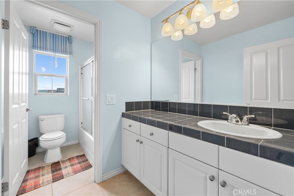 17408 Winter Pine Way Canyon Country, CA 91387 - Photo 23 of 29 a bathroom with a sink a toilet and a mirror