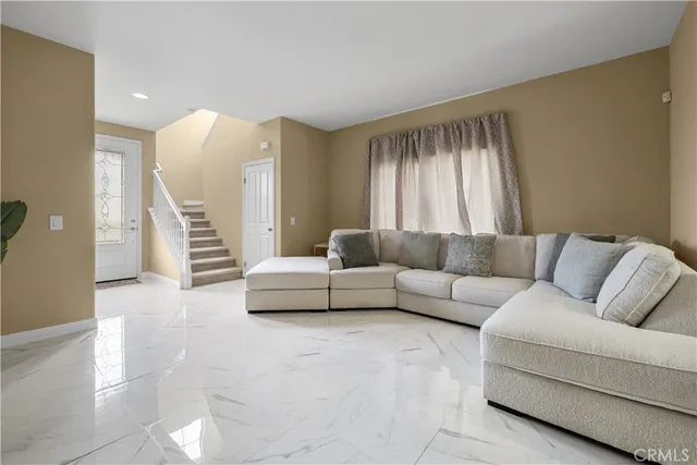 a living room with furniture and a large window