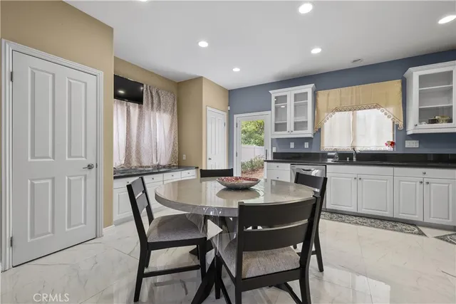 a dining room with furniture and window