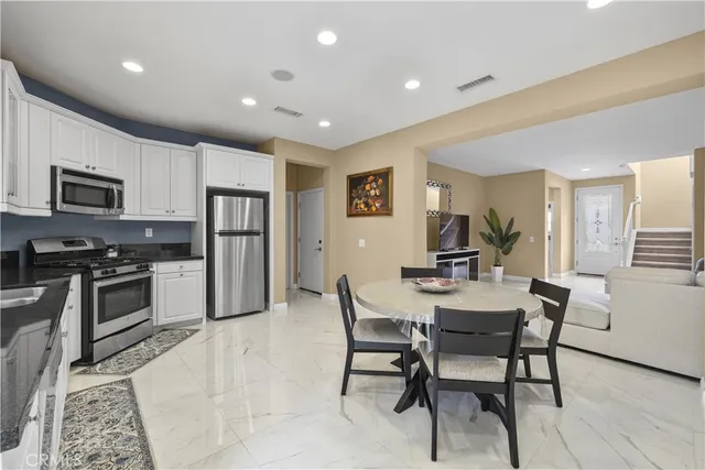 a view of kitchen with microwave stove top oven and cabinets