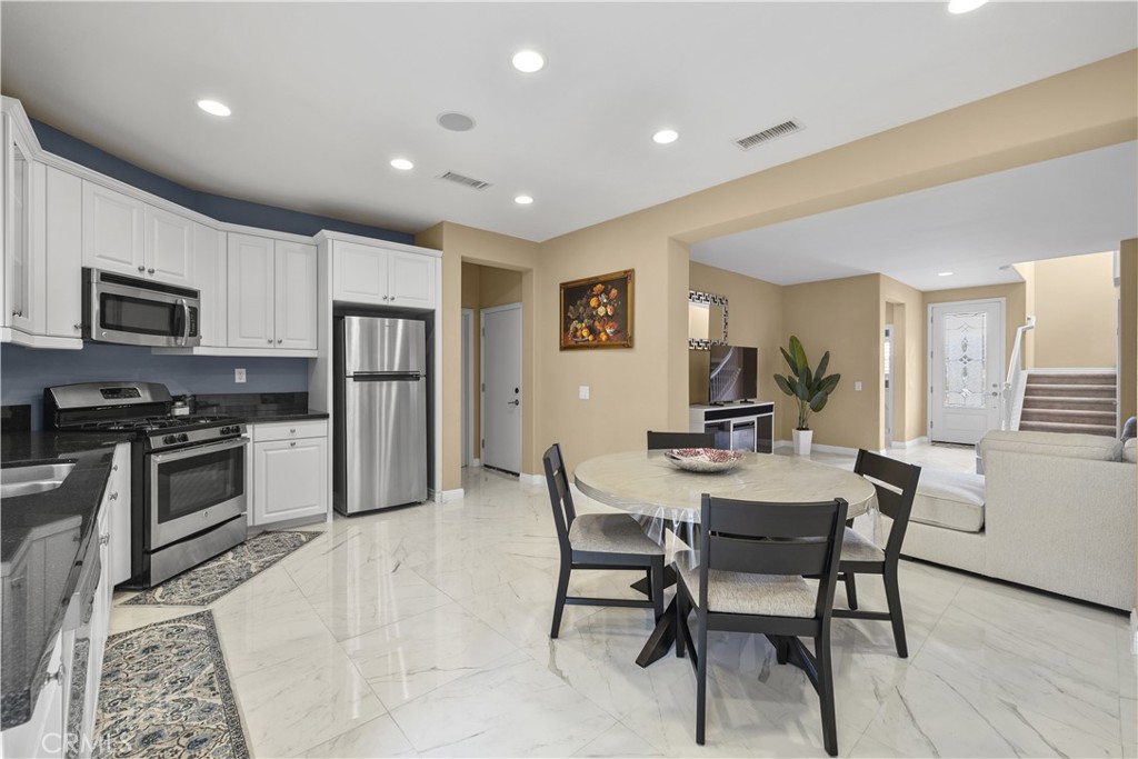 17408 Winter Pine Way Canyon Country, CA 91387 - Photo 8 of 29 a view of kitchen with microwave stove top oven and cabinets