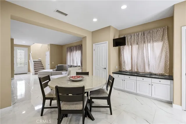 a view of a dining room with furniture and window