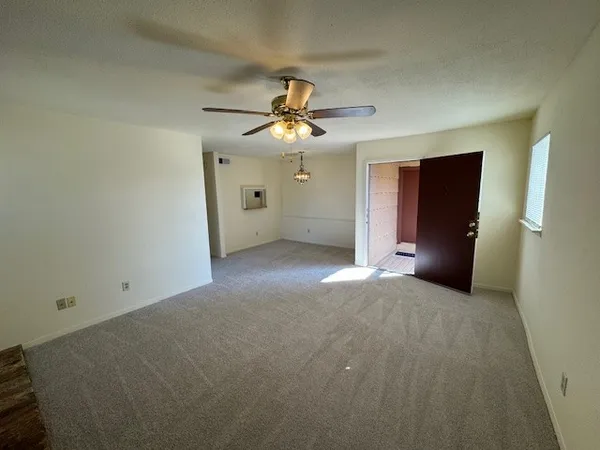 a view of a livingroom with a chandelier fan