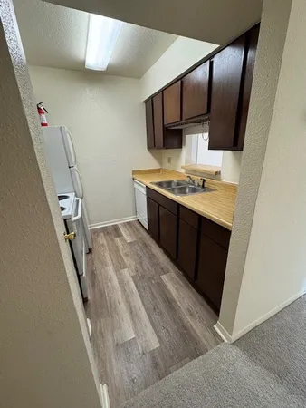 a view of kitchen with sink microwave and stove