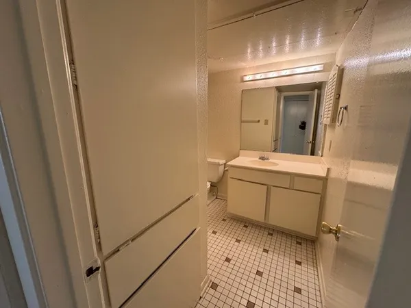 a bathroom with a sink toilet and mirror