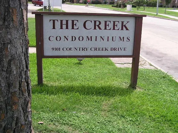 a sign broad in front of red brick house