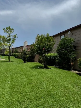 a backyard of a house with lots of green space and garden