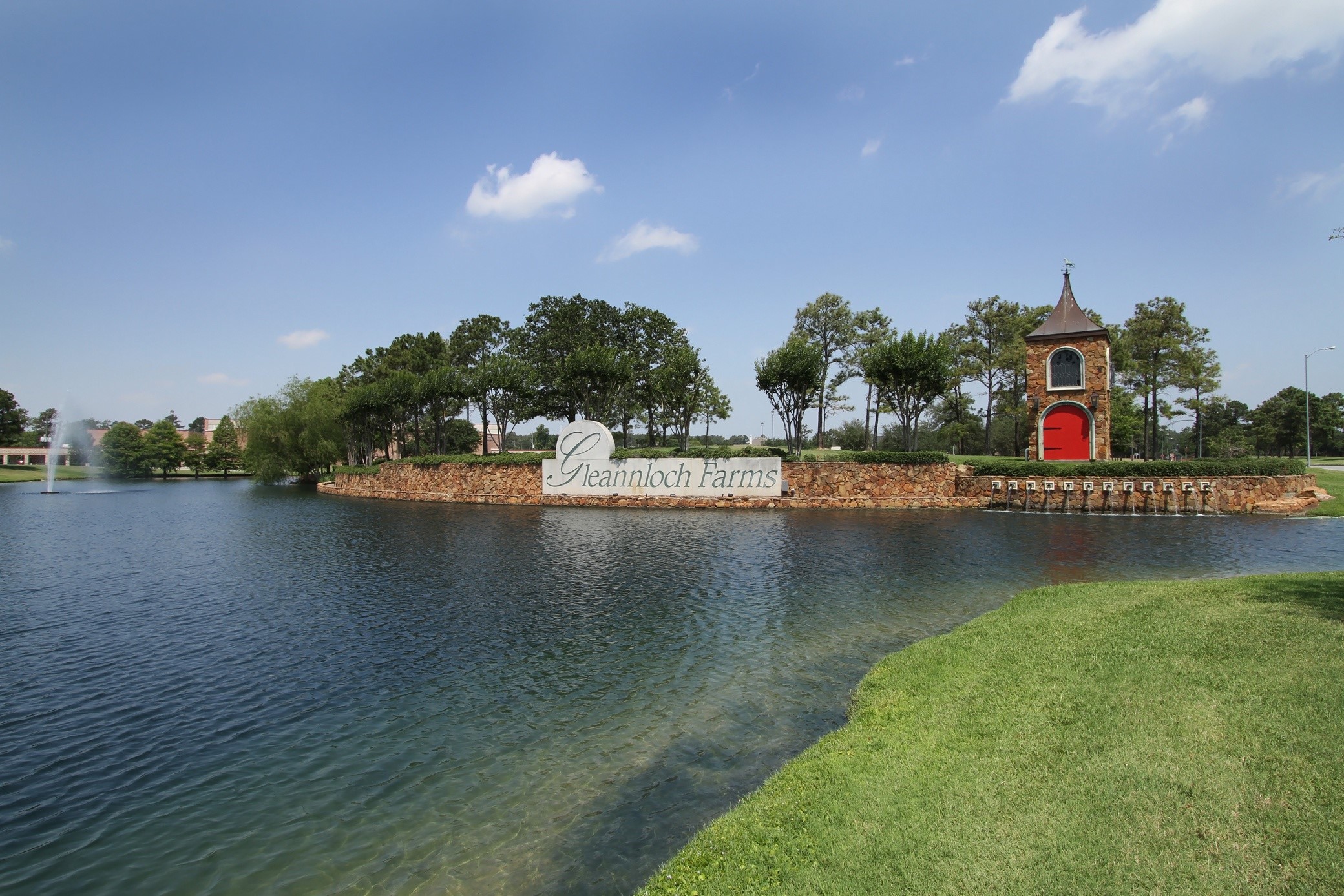 9406 Lochflora Drive Spring, TX 77379 - Photo 42 of 49 a view of a lake with boats and trees in the background