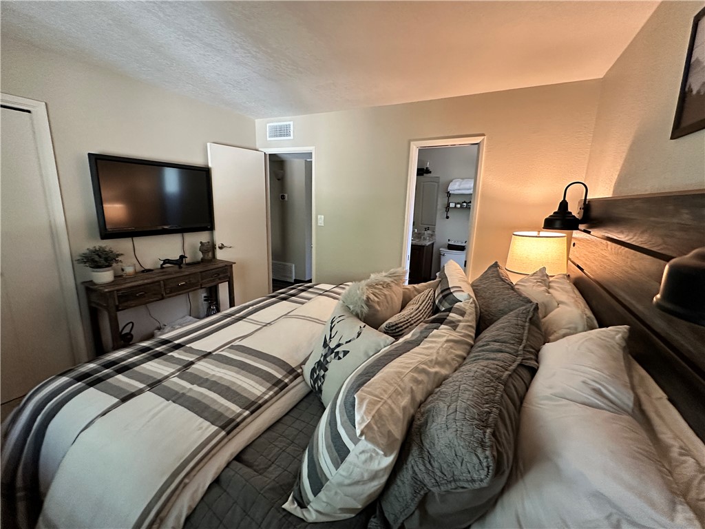 6615 Flag Mine Road Kingman, AZ 86401 - Photo 29 of 72 a bedroom with a bed and a flat screen tv