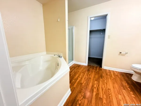 a bathroom with a bathtub and toilet