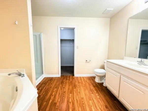 a spacious bathroom with a sink and a mirror