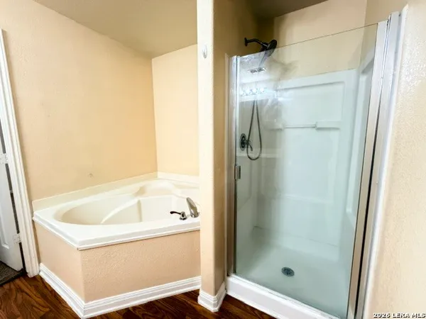a bathroom with a bathtub and a shower