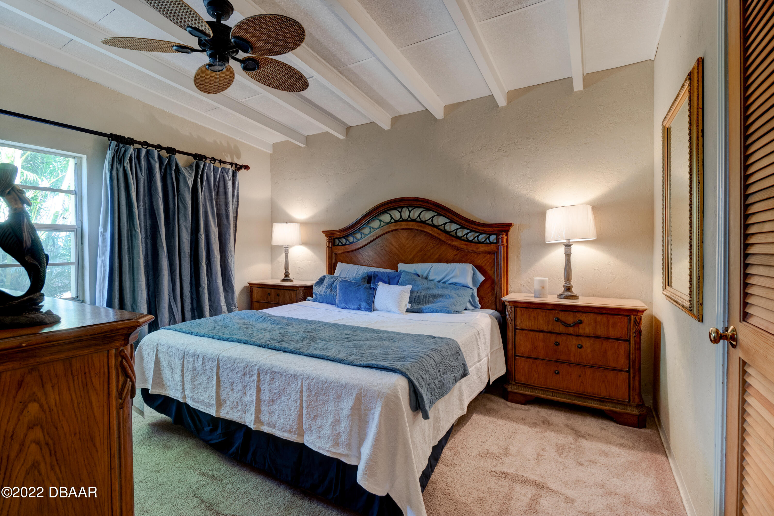 14 Maria Street Ormond Beach, FL 32176 - Photo 12 of 20 a bedroom with a bed a lamp on dresser and a window