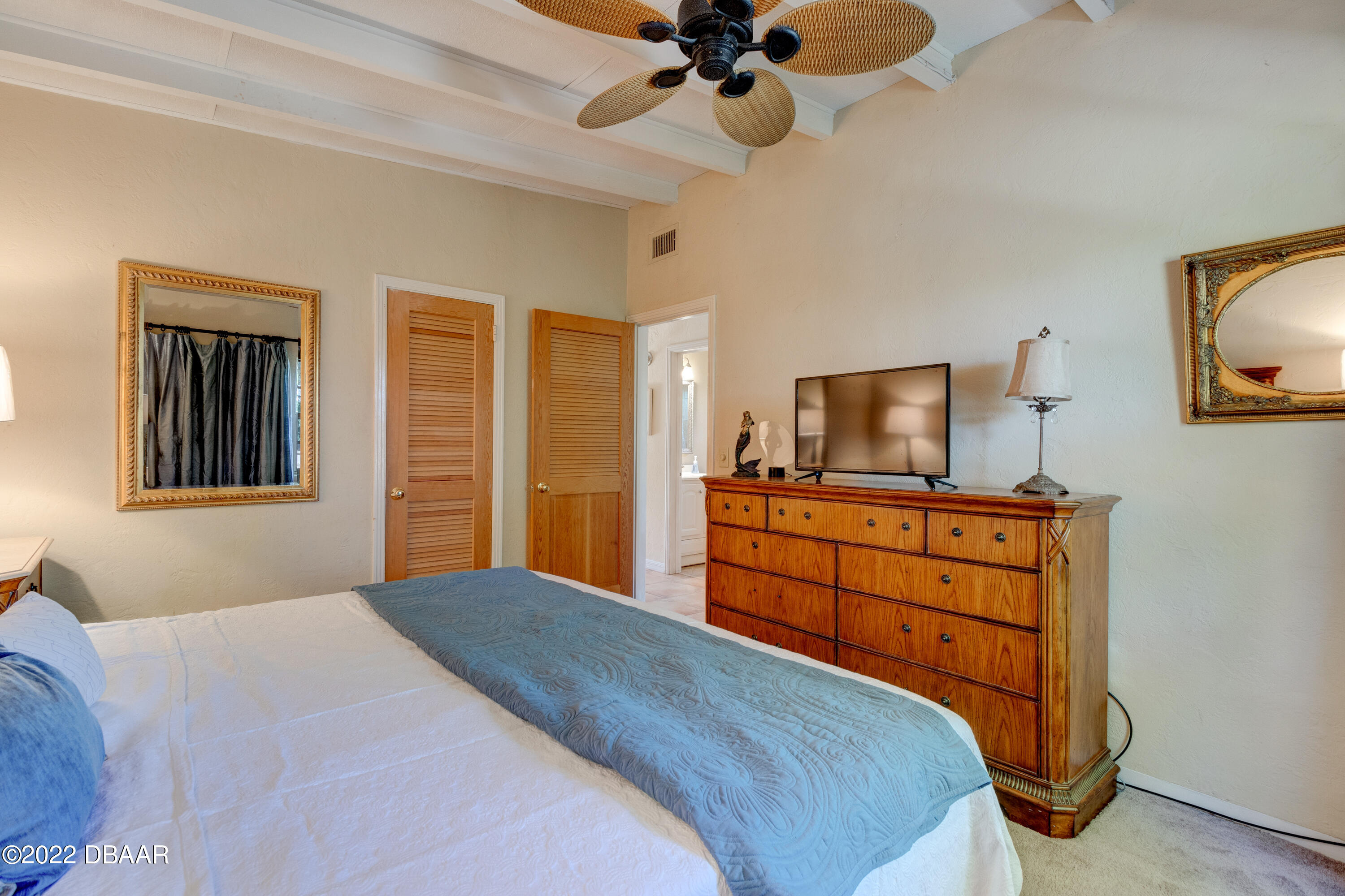 14 Maria Street Ormond Beach, FL 32176 - Photo 13 of 20 a bedroom with a bed and flat screen tv