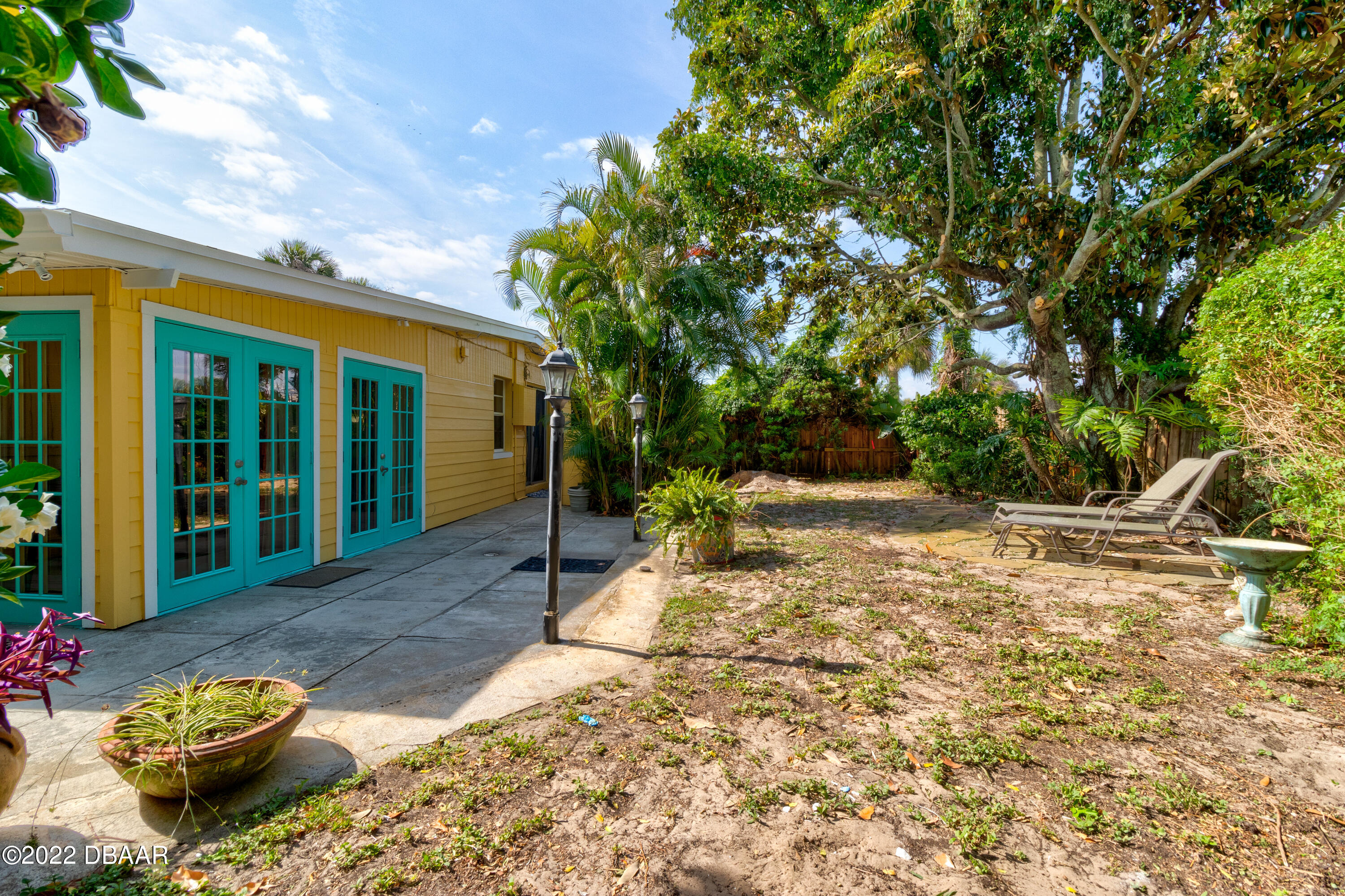 14 Maria Street Ormond Beach, FL 32176 - Photo 20 of 20 a view of a backyard with table and chairs and potted plants
