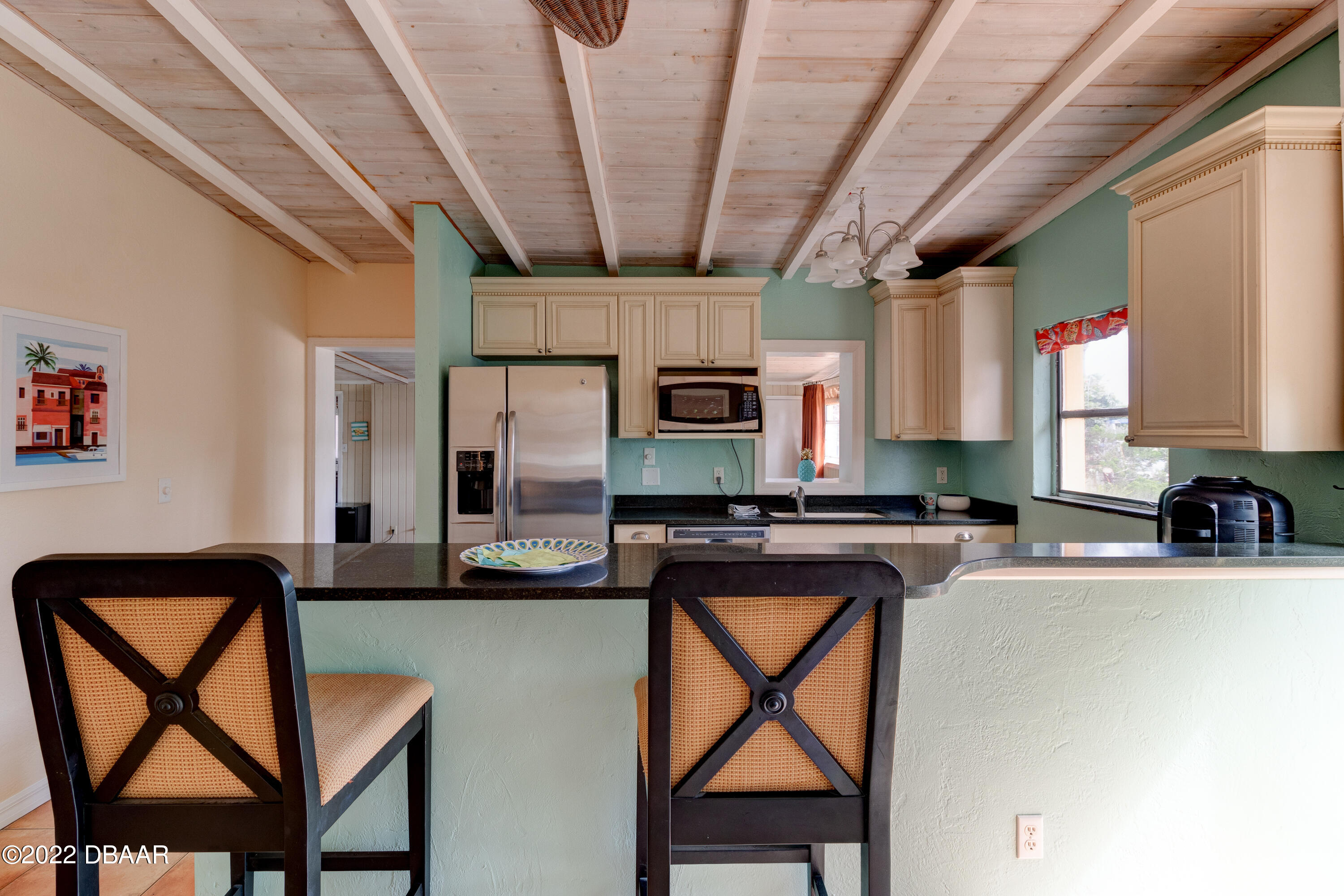 14 Maria Street Ormond Beach, FL 32176 - Photo 6 of 20 a kitchen with stainless steel appliances granite countertop table chairs sink and cabinets