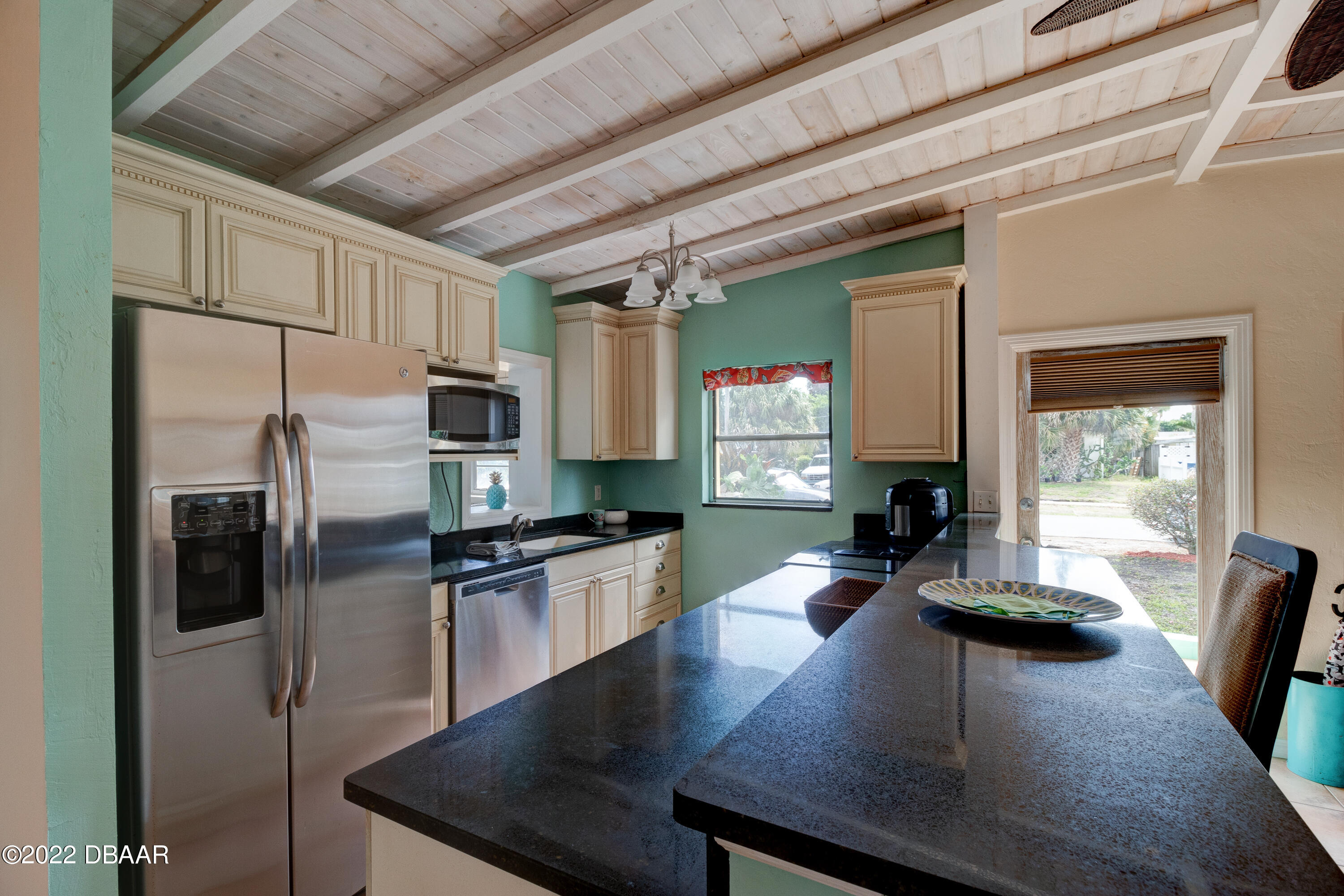 14 Maria Street Ormond Beach, FL 32176 - Photo 7 of 20 a kitchen with stainless steel appliances granite countertop a sink refrigerator stove microwave and cabinets