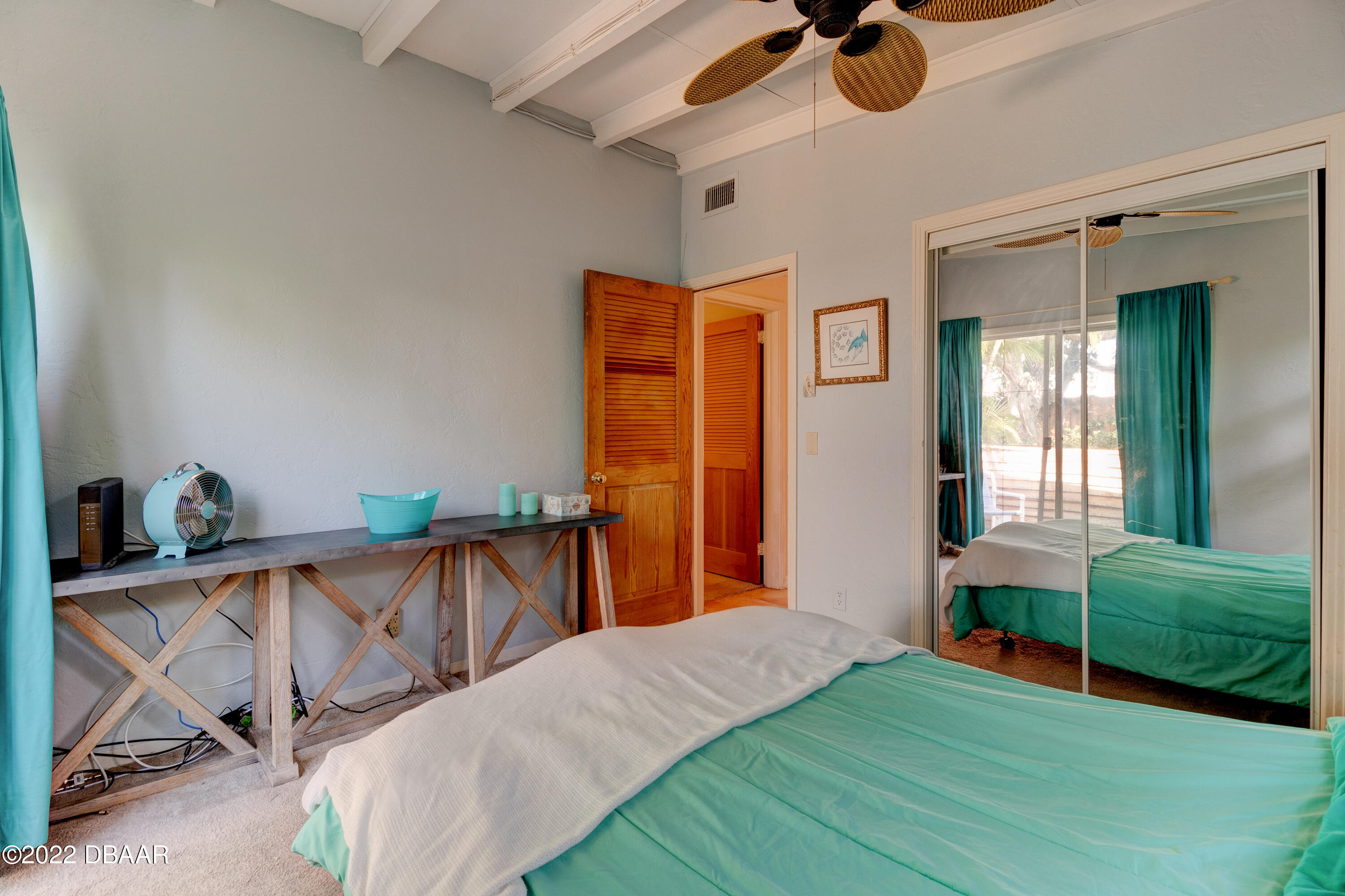 14 Maria Street Ormond Beach, FL 32176 - Photo 10 of 20 a bedroom with a bed and a chandelier