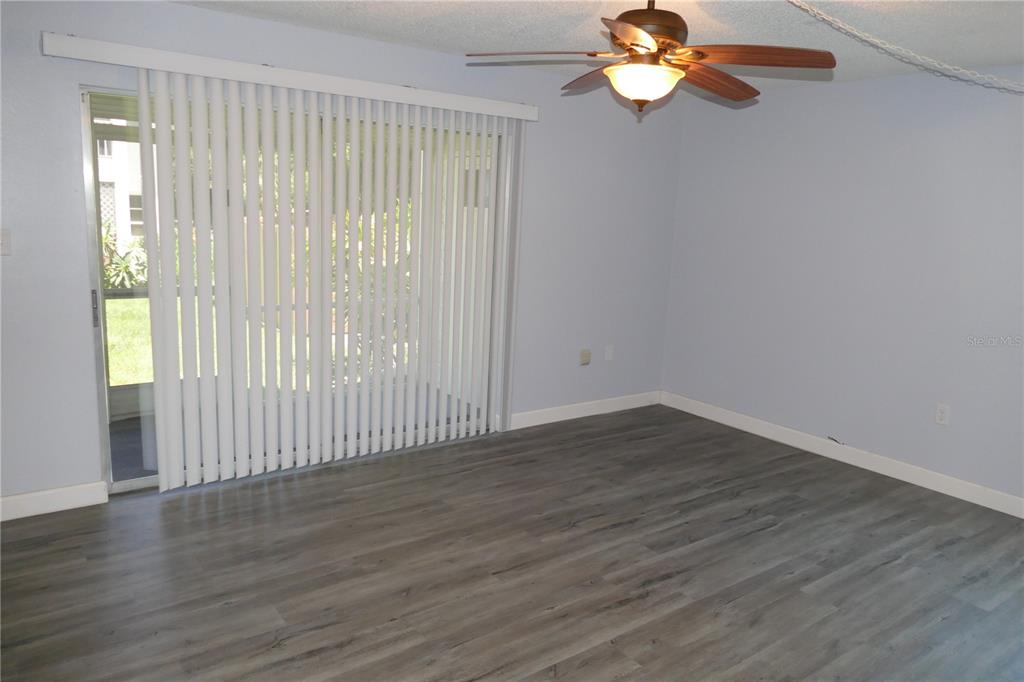 205 South McMullen Booth Road, Unit 203 Clearwater, FL 33759 - Photo 15 of 21 a view of wooden floor and chandelier fan in a room