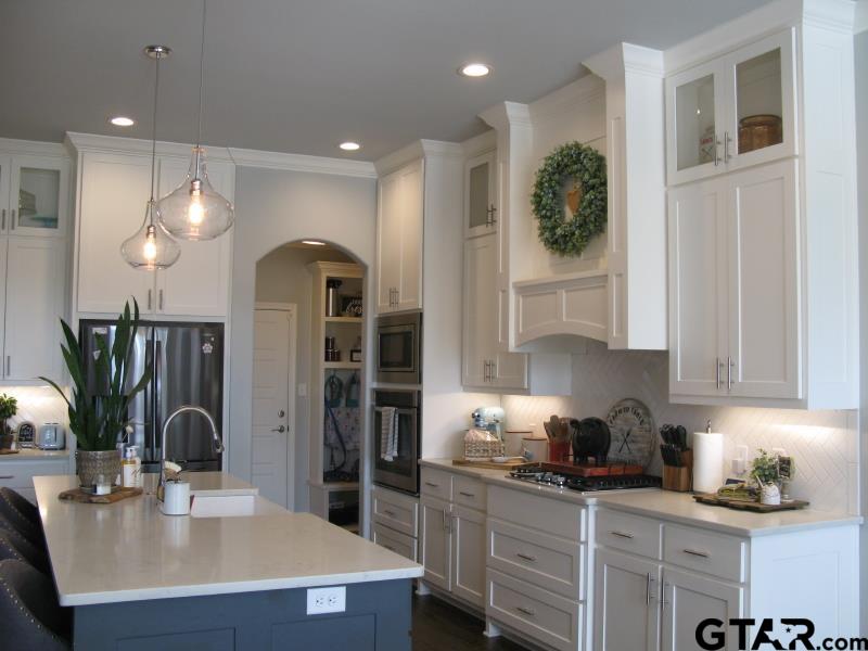 118 Nathan Road Chandler, TX 75758 - Photo 12 of 28 a kitchen with stainless steel appliances granite countertop a sink a stove and a refrigerator
