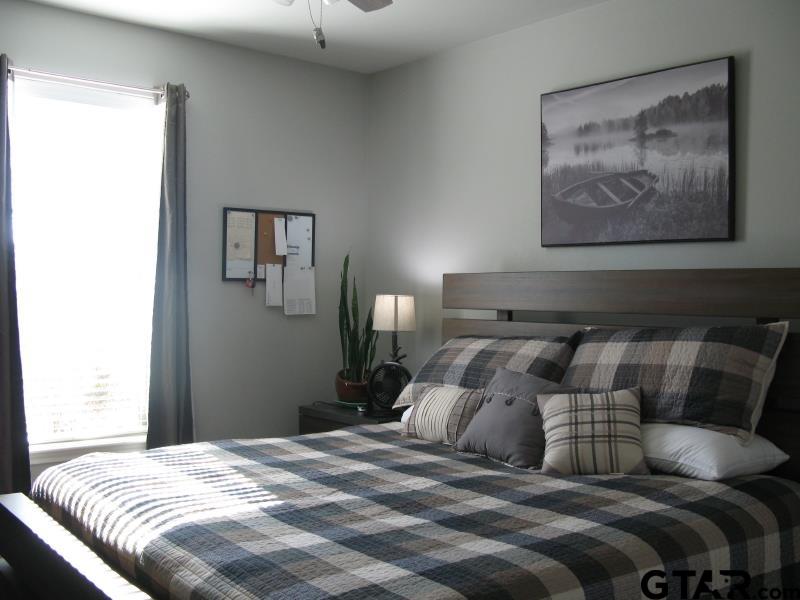 118 Nathan Road Chandler, TX 75758 - Photo 24 of 28 a bedroom with a bed and lamp