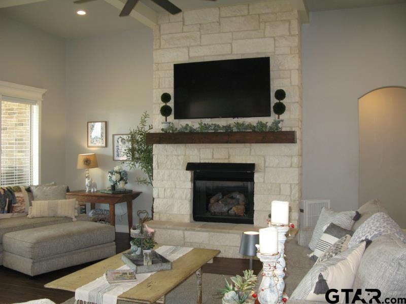 118 Nathan Road Chandler, TX 75758 - Photo 9 of 28 a living room with furniture a flat screen tv and a fireplace