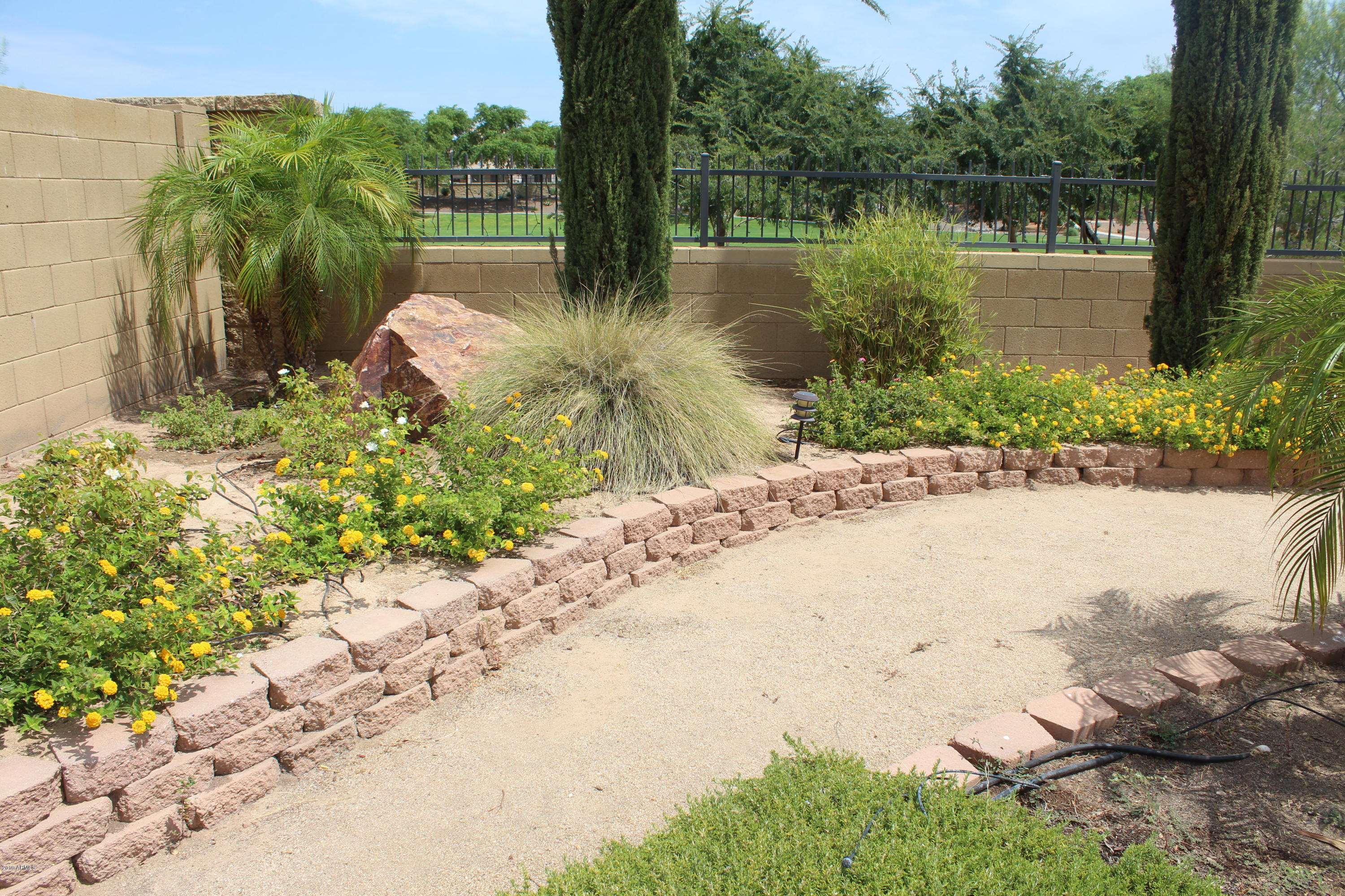 18120 West Ruth Avenue Waddell, AZ 85355 - Photo 6 of 21 a lake view with a wooden fence