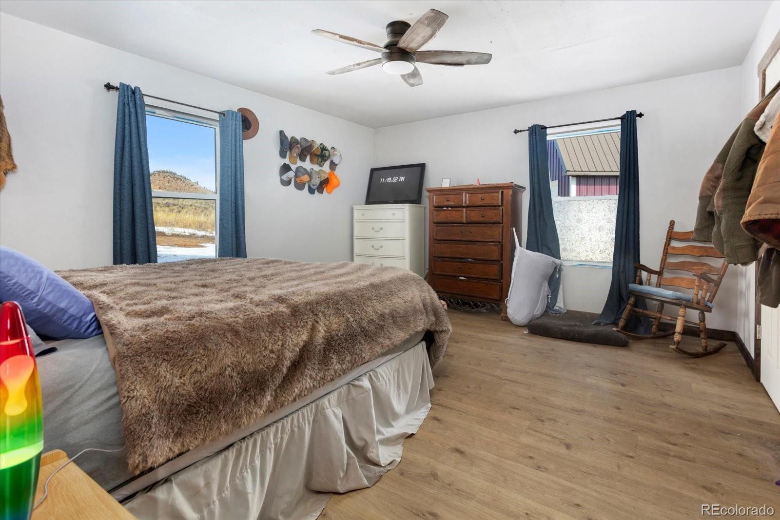 51624 Co Road Villa Grove, CO 81155 - Photo 14 of 50 a bedroom with a bed closet and a flat tv screen
