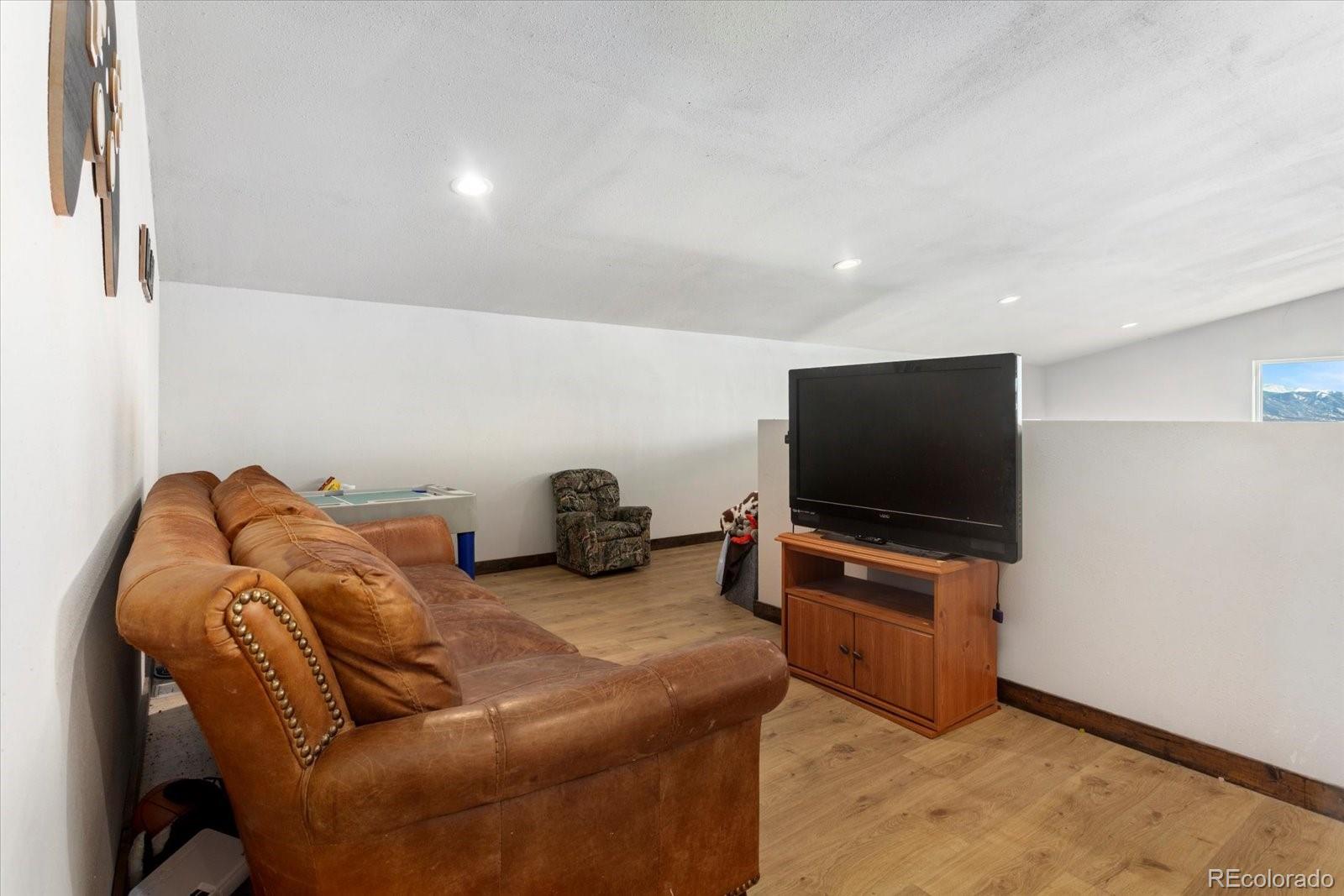 51624 Co Road Villa Grove, CO 81155 - Photo 25 of 50 a living room with furniture and a flat screen tv