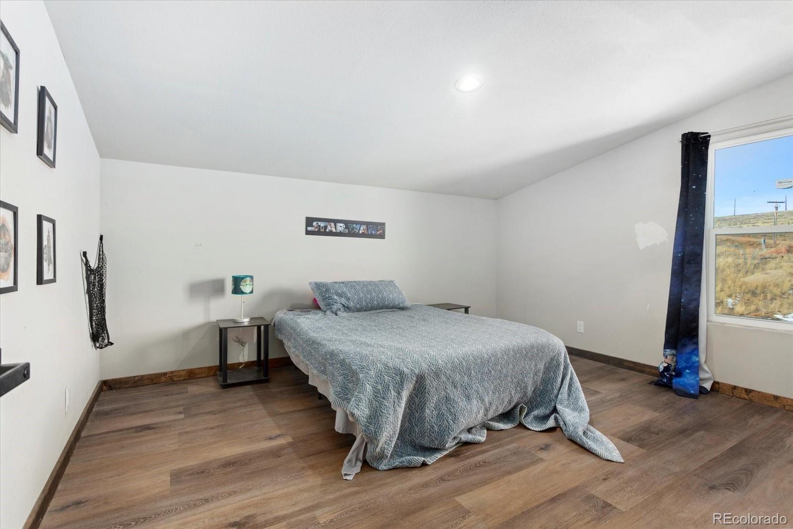 51624 Co Road Villa Grove, CO 81155 - Photo 29 of 50 a bedroom with a bed and a table in it