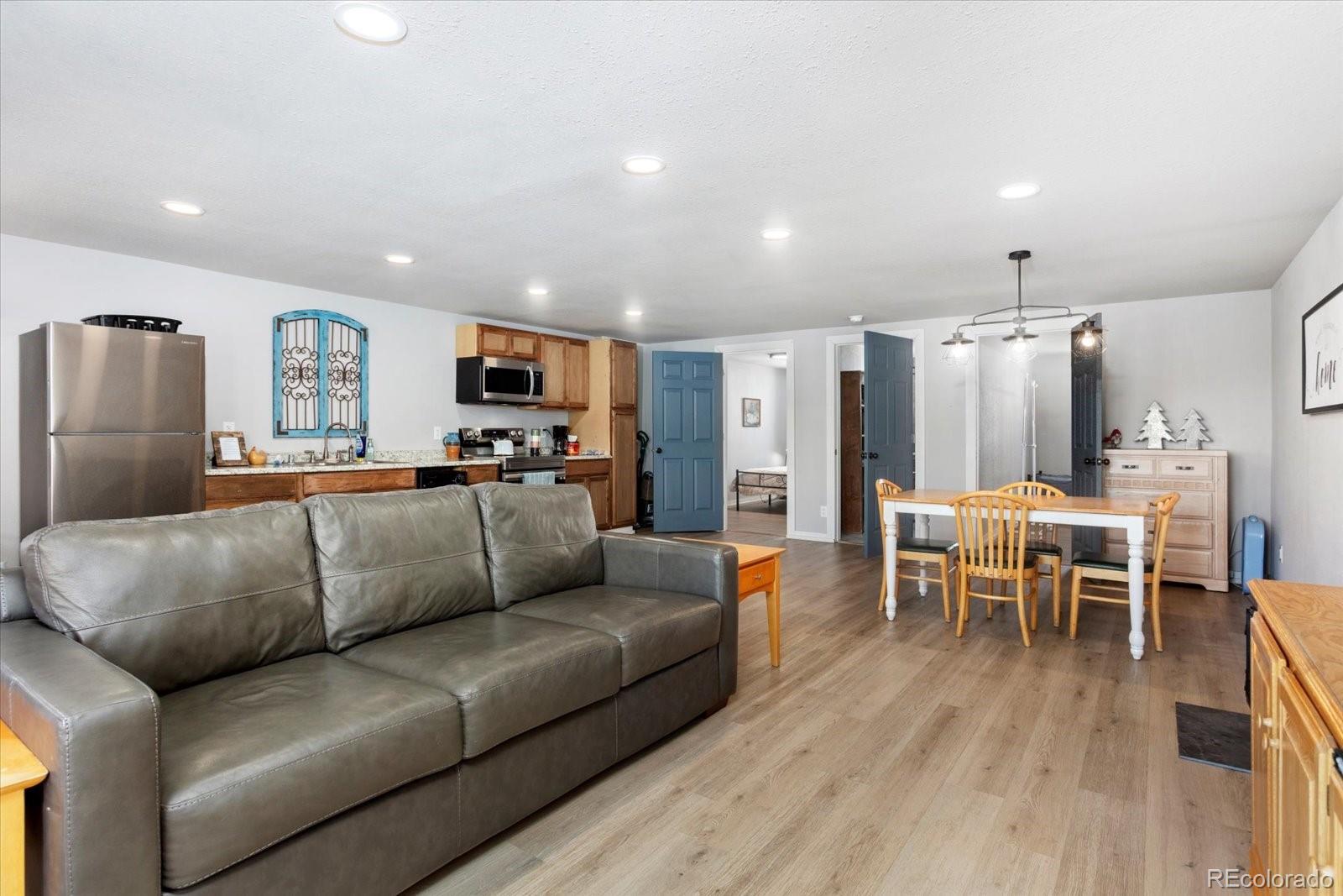 51624 Co Road Villa Grove, CO 81155 - Photo 39 of 50 a living room with furniture and a dining table with wooden floor