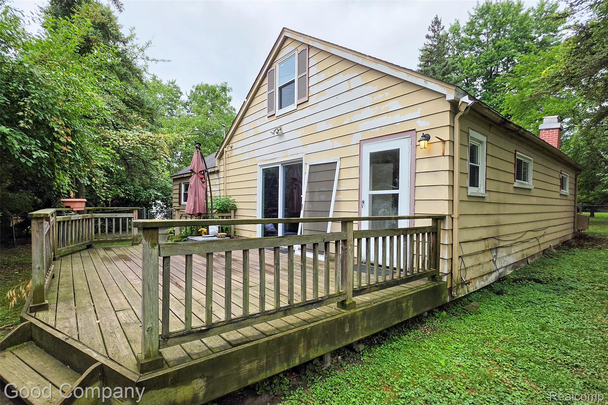 3685 Cone Avenue Rochester, MI 48309 - Photo 21 of 23 Wood deck with railing, sliding glass door, exterior siding, and brick chimney