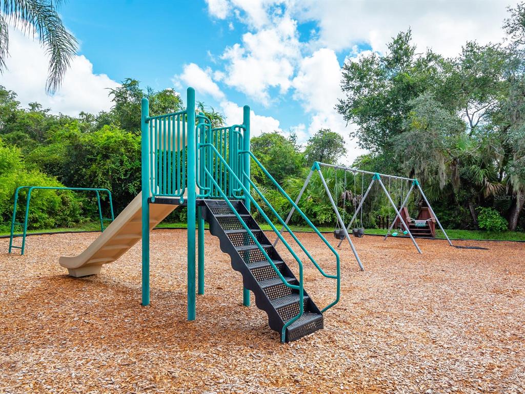6524 Copper Ridge Trail University Park, FL 34201 - Photo 26 of 29 a view of outdoor space with a slide and bench