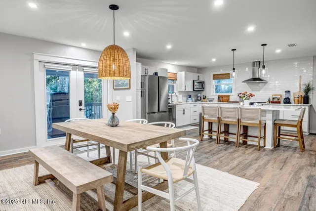 a kitchen with stainless steel appliances kitchen island a refrigerator and a stove top oven