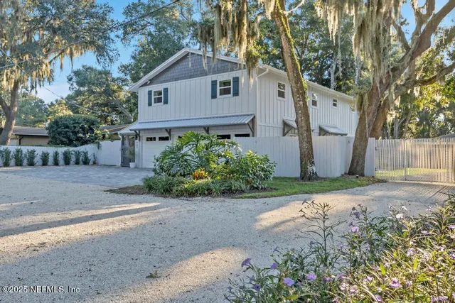 a front view of a house with a yard and a garage