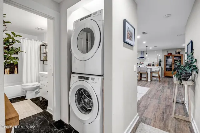 a view of a livingroom with furniture staircase and white kitchen