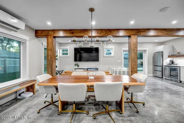 a view of a house with a yard and large tree