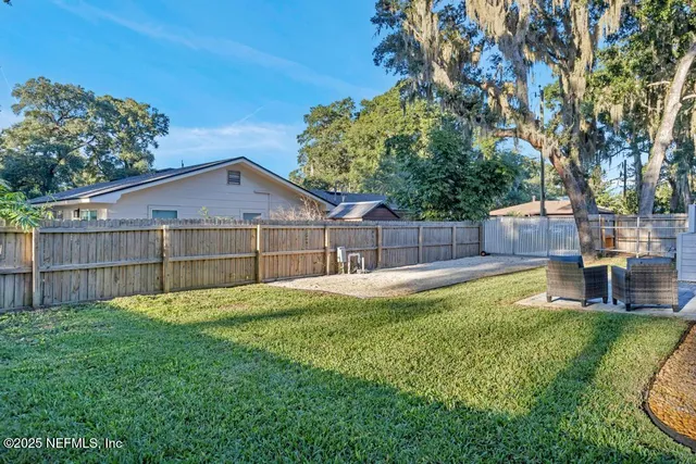 a view of a house with pool and a yard